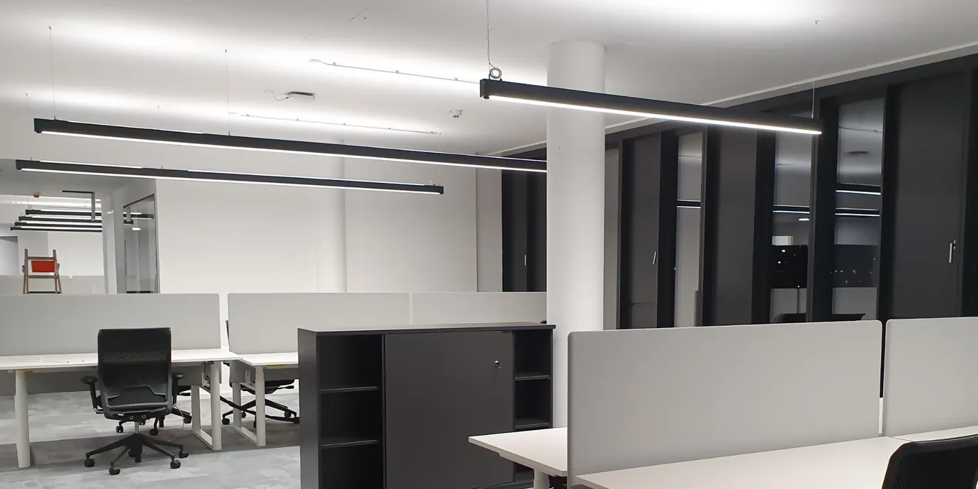 Leeres Büro mit modernem Büro-Mobiliar und Langfeldleuchten an der Decke